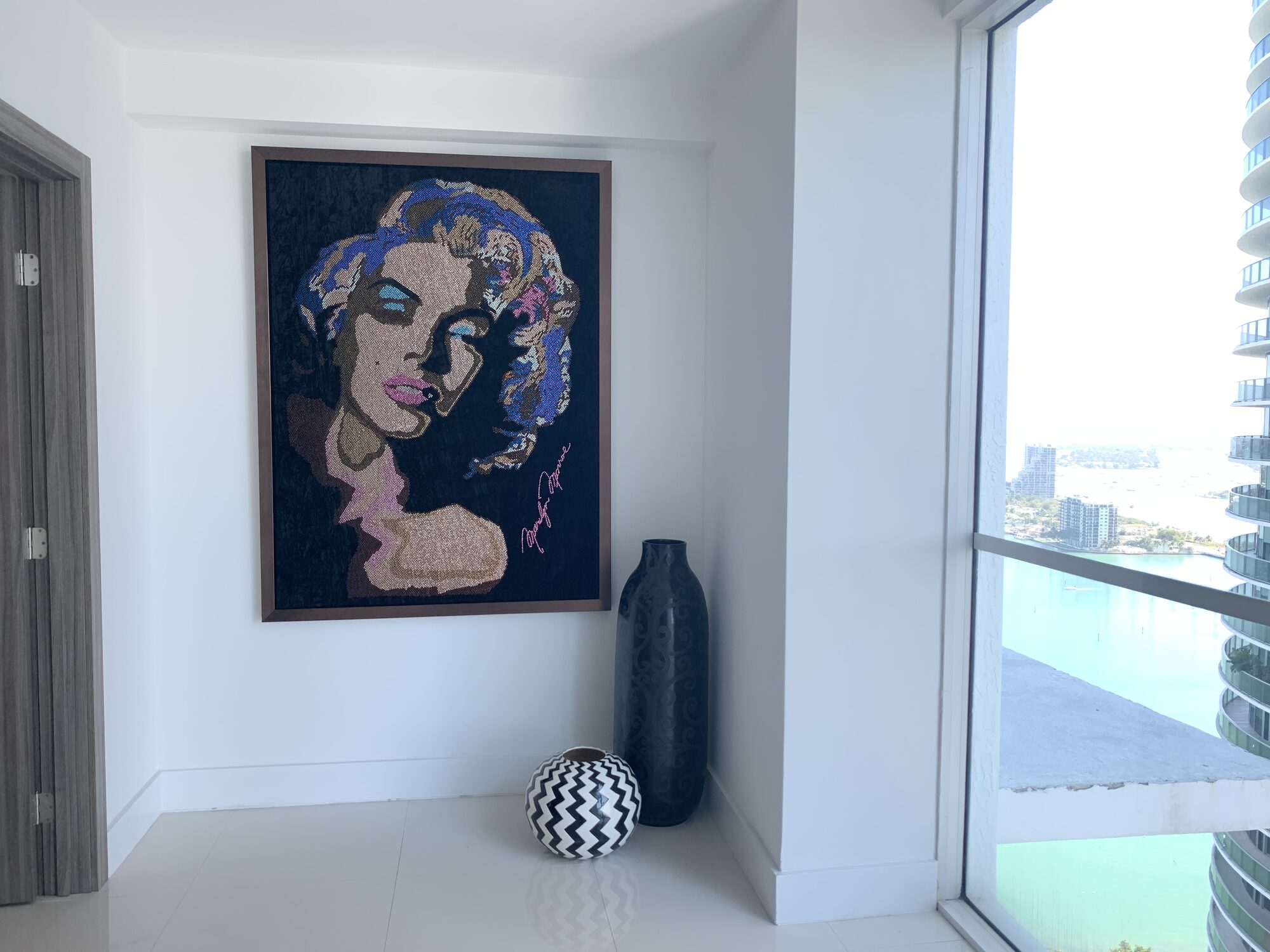 Mosaic portrait artwork staged in a waterfront residence