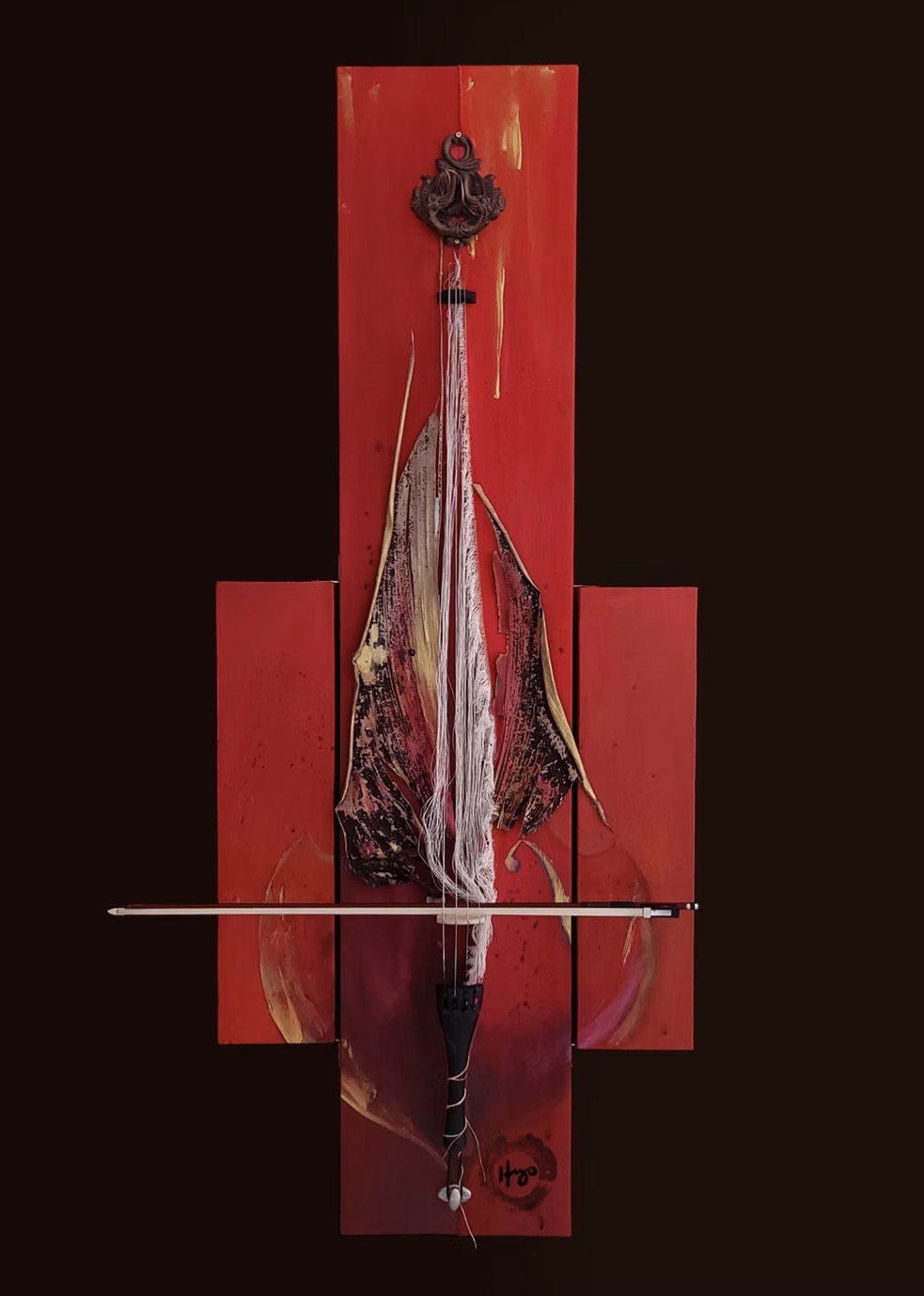 Red mixed-media assemblage with a violin bow and cascading strings, signed by the artist