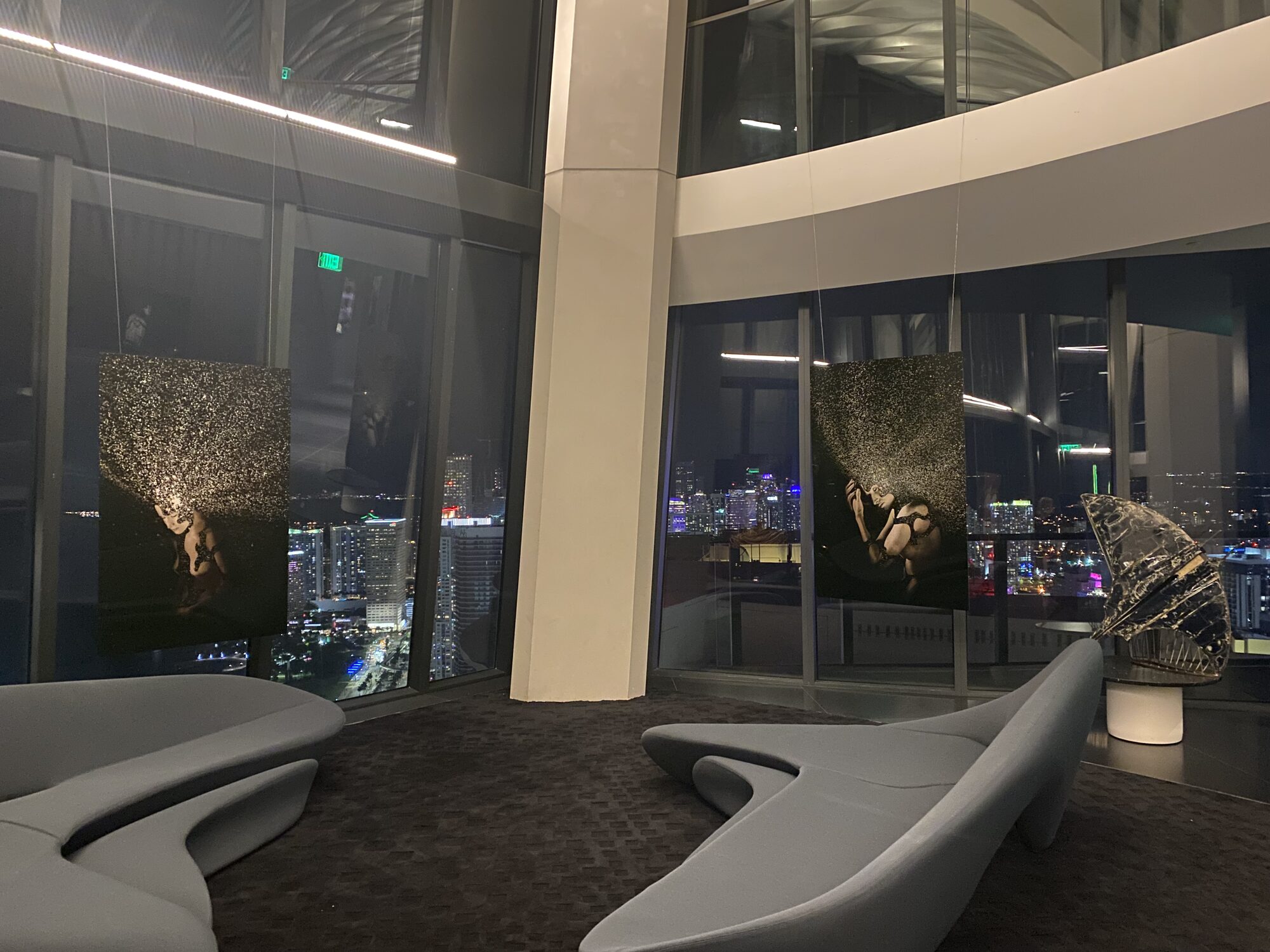 Suspended photographic works above the Miami night skyline at 1000 Museum, Miami