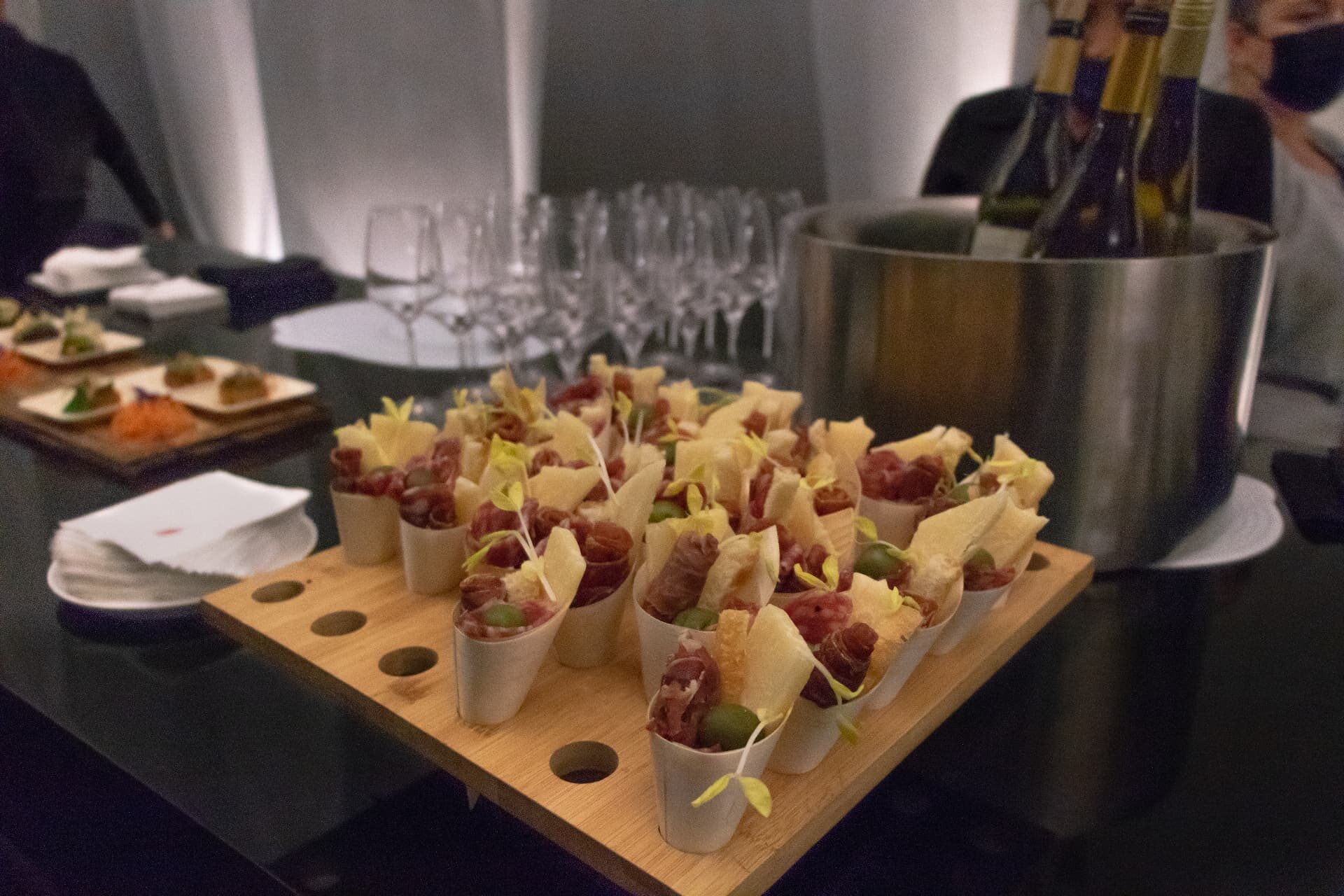 Curated charcuterie cones and chilled wine at a private event